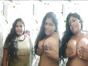 An Indian woman of a certain age flaunts her large breasts and curvaceous buttocks.
